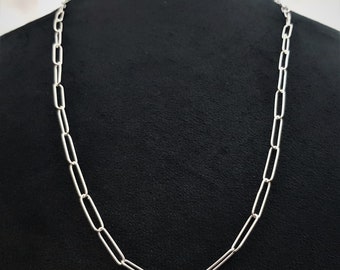 May include: A silver chain necklace with a simple, linked design. The chain is made of oval-shaped links.