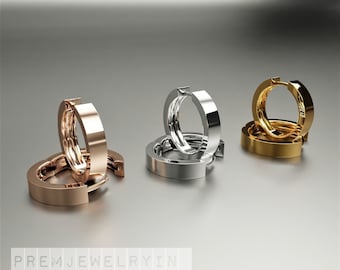 Könnte beinhalten: Drei Paar Creolen in verschiedenen Metalloberflächen: Roségold, Silber und Gold. Die Ohrringe sind übereinander gestapelt.