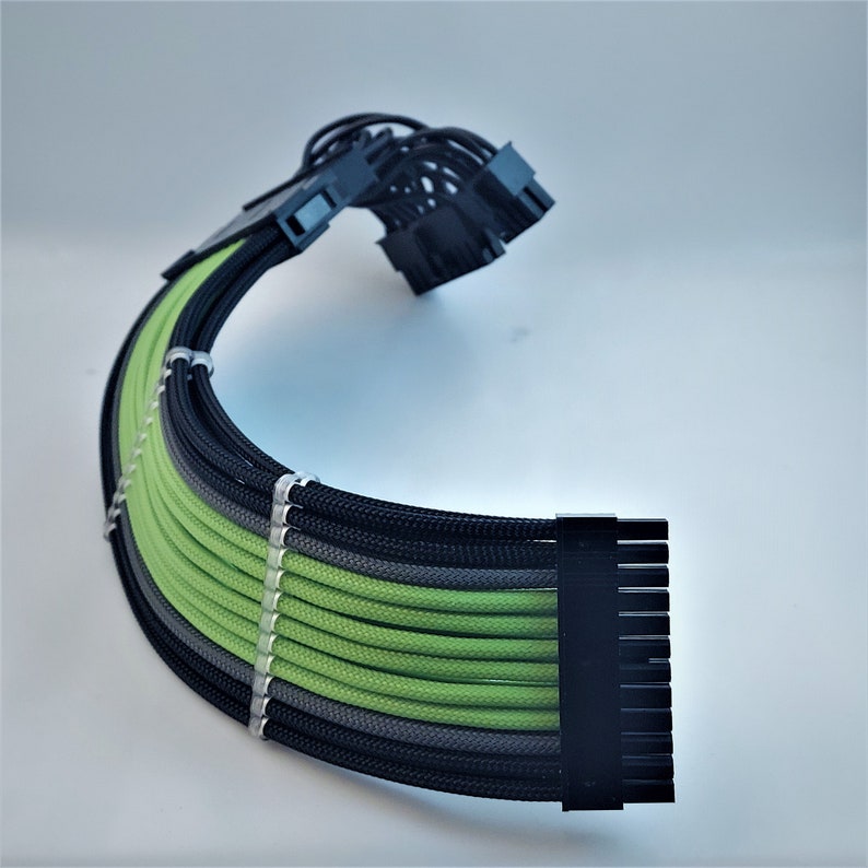 May include: A black and green computer cable with multiple connectors. The cable is sleeved with black, gray, and green braided sleeving.