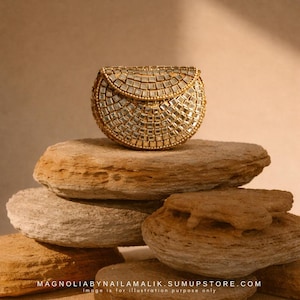 May include: A semi-circular gold clutch bag featuring an intricate mosaic of small, square, reflective mirror tiles arranged in a grid pattern across the entire exterior surface, including the curved flap closure with a beaded gold trim edge.