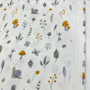 May include: White fabric with a repeating pattern of grey snails, yellow mushrooms, and grey leaves. The background is white.