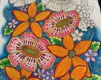 May include: A colorful floral illustration with orange, pink, and yellow flowers on a blue background. The flowers have intricate details and are surrounded by green leaves.