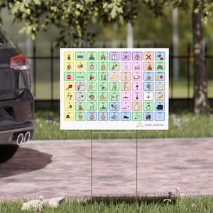 May include: A white sign with a grid of colorful squares containing various symbols and icons. Each square has a different color and contains a black and white image. The sign is on a metal stand and is in front of a green lawn. The text at the bottom of the sign reads "aac.and.me".
