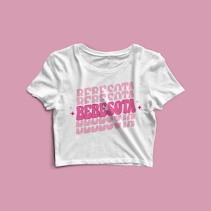 May include: White cropped t-shirt with the text "BEBESOTA" repeated in pink and white, with a pink heart and stars.