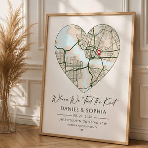 May include: A framed vertical print featuring a heart-shaped map with a red location pin. Text reads: Where We Tied the Knot, DANIEL & SOPHIA, 08. 22. 2026, 36°50'53.9"N 76°15'46.7"W, NORFOLK STATE UNIVERSITY, and a small heart symbol at the bottom.