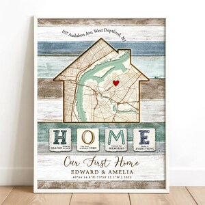 May include: A framed print featuring a house-shaped map with a red heart marking a location. The print includes the address "107 Audubon Ave, West Deptford, NJ" and the text "Our First Home" with names and coordinates. The word "HOME" is spelled out below.