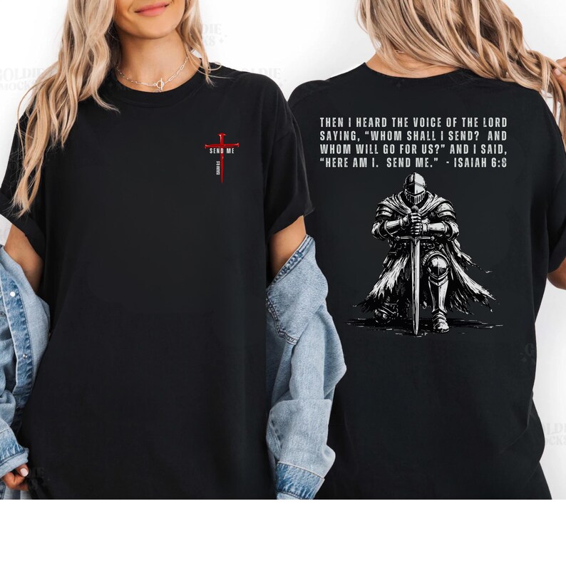 May include: A black t-shirt featuring a small red cross graphic on the front chest with the text SEND ME. The back displays a graphic of a knight kneeling with a sword and the text: THEN I HEARD THE VOICE OF THE LORD SAYING, WHOM SHALL I SEND?