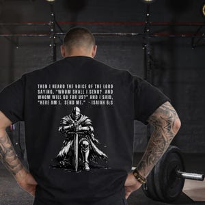 May include: A black t-shirt featuring a white graphic of a knight kneeling with a sword. Above the knight, the text reads: THEN I HEARD THE VOICE OF THE LORD SAYING, "WHOM SHALL I SEND? AND WHOM WILL GO FOR US?" AND I SAID, "HERE AM I. SEND ME." - ISAIAH 6:8