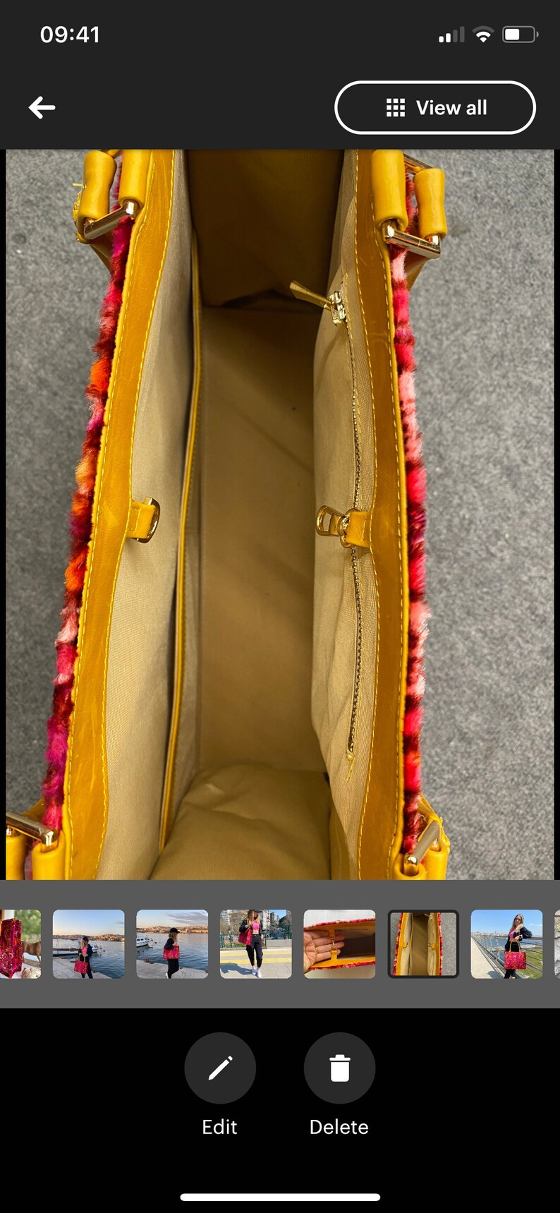 May include: A yellow faux fur tote bag with a red, orange, and pink trim. The bag has a zipper closure and a small interior pocket. The bag is open and the interior is visible.