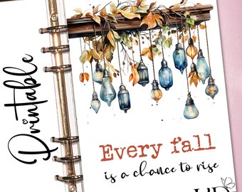 May include: Printable quote with a watercolour illustration of autumn leaves and hanging lights. The quote reads "Every fall is a chance to rise".