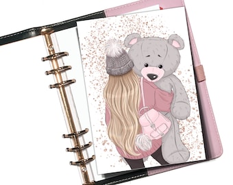 May include: A girl with long blonde hair wearing a pink sweater and a grey and white beanie holds a large grey teddy bear. The background is a white page with a rose gold glitter pattern.