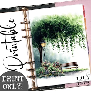 May include: A planner insert featuring a watercolor illustration of a park scene with a bicycle, a wooden bench, a street lamp, and a large tree with hanging vines. The text "PRINTABLE" and "PRINT ONLY!" appear on the left, with "KEZAKU DESIGN" at the bottom right.