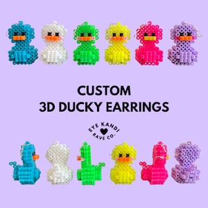 May include: Custom 3D ducky earrings in various colors, including blue, white, green, yellow, pink, and purple. The earrings are made of plastic beads and have a cute, cartoonish design. The earrings are sold by Eye Kande Rave Co.