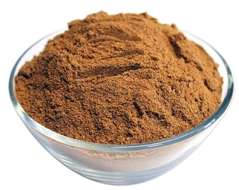 May include: A glass bowl filled with a heaping amount of brown cinnamon powder. The powder is finely ground and has a rich, warm color.