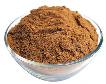 May include: A glass bowl filled with a heaping amount of brown cinnamon powder. The powder is finely ground and has a rich, warm color.