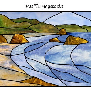 May include: Stained glass artwork depicting a coastal landscape with the text "Pacific Haystacks". The artwork features rolling hills, golden rock formations, and a flowing blue sea. Black lines define the shapes and colors.