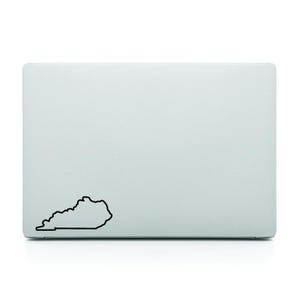 Puede incluir: Un ordenador portátil con un contorno negro del estado de Kentucky en la tapa.