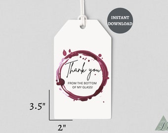 Puede incluir: Etiqueta de regalo blanca con una mancha de vino tinto en forma de anillo y el texto "¡Gracias desde el fondo de mi copa!" La etiqueta mide 8,9 cm de alto y 5,1 cm de ancho.