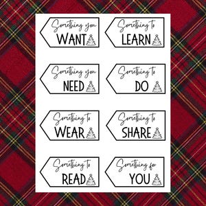 Pu&ograve; includere: Bigliettini bianchi con testo nero e grafica di albero di Natale. I bigliettini recitano: "Something you WANT", "Something to LEARN", "Something you NEED", "Something to DO", "Something to WEAR", "Something to SHARE", "Something to READ" e "Something for YOU".