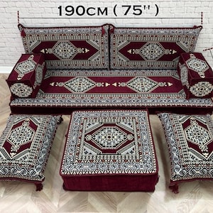 May include: A floor seating set in deep burgundy with intricate geometric patterns in white, black, and grey. The set includes a long bench cushion, two armrests, two rectangular floor pillows, and a square ottoman, measuring 190cm (75") by 70cm (28").