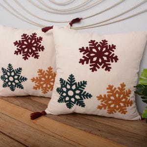 Snowflake Embroidered Pillow – Winter Cushion Cover with Burgundy Tassels