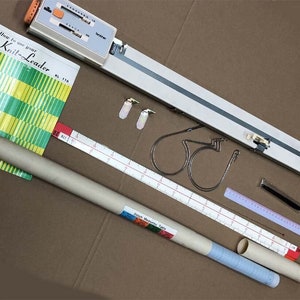 May include: A Knit-Leader knitting gauge with instructions, a ruler, two measuring tapes, two metal rings, two metal clips, and two cardboard tubes.