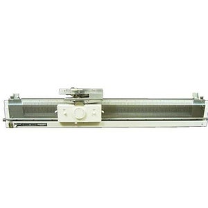 May include: A white industrial knitting machine with a silver metal needle bed and a silver metal carriage.