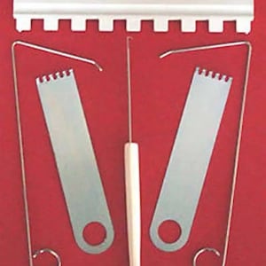 May include: A set of lock picking tools, including a rake, two hook tools, and a tension wrench. The tools are silver and have a serrated edge. The tools are on a red background.