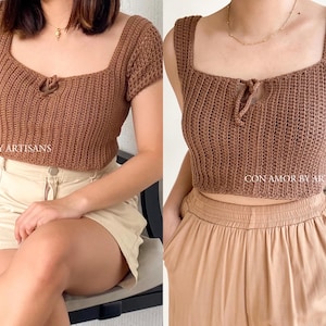 May include: Two brown crochet tops with a square neckline and a tie detail at the center. The top on the left has short sleeves, while the top on the right is sleeveless. Both tops are made with a chunky yarn.