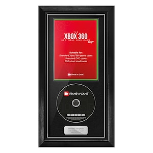 May include: Black framed display for Xbox 360 game cases and DVDs. The display includes a red and green insert with the text "XBOX 360 USE YOUR OWN GAME". A game disc is displayed below the insert.