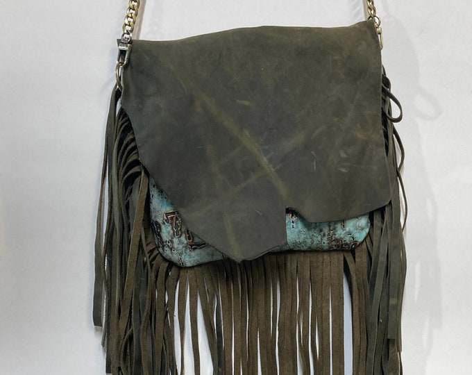 Handmade Boho inspired leather purse. One of a kind, handmade purse fully lined. 9” wide and 8”tall with 8” hand cut fringe.