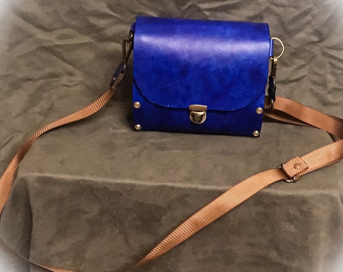 Handmade blue leather purse with wood sides. One of a kind, handmade purse lined with cork fabric. Includes a matching wallet.