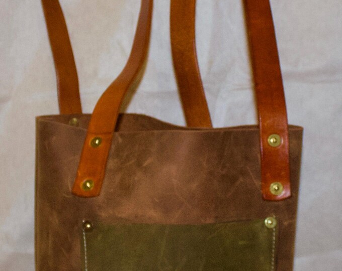 Handmade over the shoulder Tote Style leather purse. 8” wide, 11”tall and 4” thick, with 14” handles.