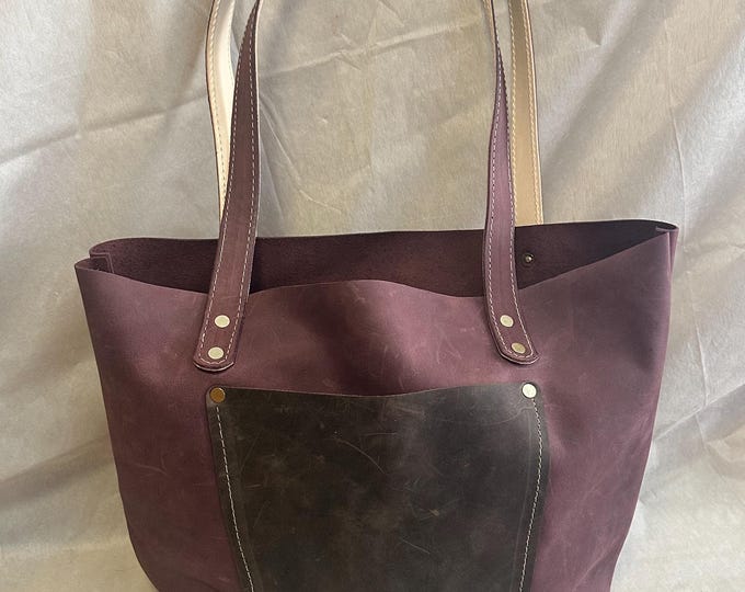 Handmade over the shoulder Tote Style leather purse. 8” wide, 11”tall and 4” thick, with 14” handles.