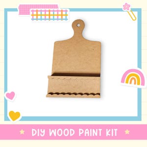 May include: A DIY wood paint kit made of light brown wood. The kit is shaped like a cutting board with a handle and a scalloped edge. The text "DIY WOOD PAINT KIT" is at the bottom of the image.
