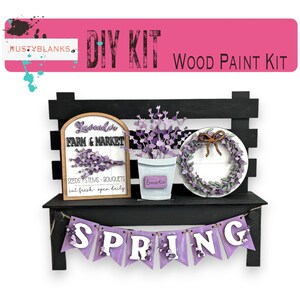 May include: DIY wood paint kit featuring a lavender farm and market sign, a potted lavender plant, a wreath, and a spring banner. The kit includes all the pieces needed to create a charming farmhouse-style decor.