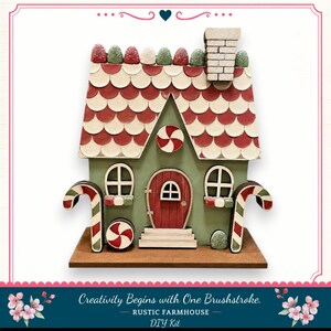 A whimsical, candy-themed house made of candy pieces, including a candy cane and a candy apple, set against a white background.