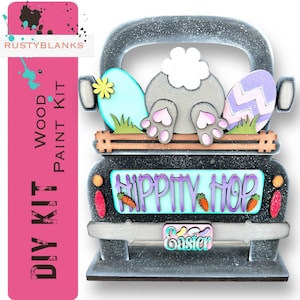 May include: DIY wood paint kit featuring a black truck with a bunny rabbit sticking its rear end out of the truck bed. The truck has a sign that says "Hippity Hop" and a license plate that says "Easter".