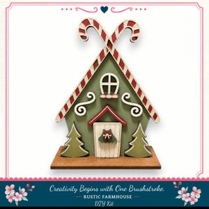 A DIY kit for creating a rustic farmhouse-style candy cane house, featuring a green and red color scheme with candy cane decorations and a wreath on the front door.