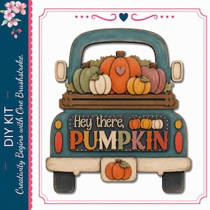 May include: A teal truck-shaped wooden DIY kit featuring a bed filled with assorted pumpkins in orange, green, and cream colors. The tailgate displays the text "Hey there, PUMPKIN" in multi-colored lettering, with a small pumpkin on the bumper.
