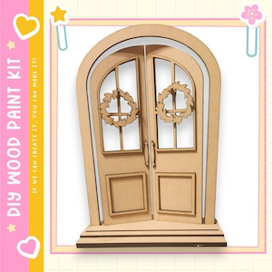 May include: A DIY wood paint kit featuring a wooden door with two panels, each with a window and a wreath. The kit includes the text "DIY WOOD PAINT KIT" and "IF WE CAN CREATE IT, YOU CAN MAKE IT!"