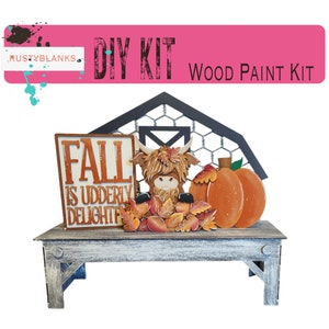 May include: DIY wood paint kit featuring a farmhouse style barn with a Highland cow, pumpkin, and fall leaves. The sign reads "Fall is udderly delightful".