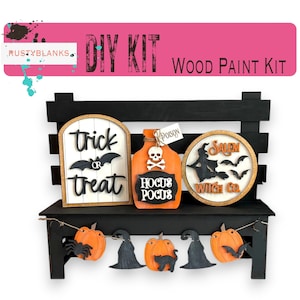 May include: DIY Halloween wood paint kit with a black painted bench, a trick or treat sign, a Hocus Pocus bottle, a Salem Witch Co. sign, and a garland of pumpkins, bats, and witches hats.