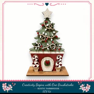 A Christmas tree-shaped object with a wreath and other decorations, placed on a wooden base. The object appears to be a DIY kit for creating a rustic farmhouse-style Christmas tree.