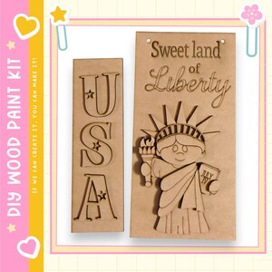 May include: DIY wood paint kit featuring two wooden panels. One panel spells out "USA" with star accents. The other panel depicts the Statue of Liberty with the text "Sweet land of Liberty" and "July IV".