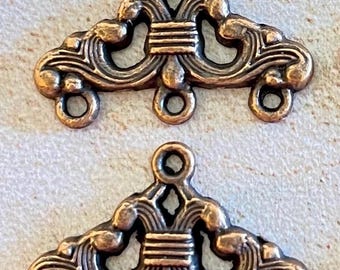 May include: Two antique gold-toned metal decorative pieces with intricate designs and three loops on the bottom.