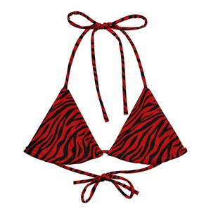 May include: A red and black zebra print bikini top with adjustable straps and a tie closure at the back.