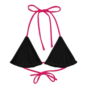 May include: A black triangle bikini top with pink straps and ties. The top has a ruffled edge.