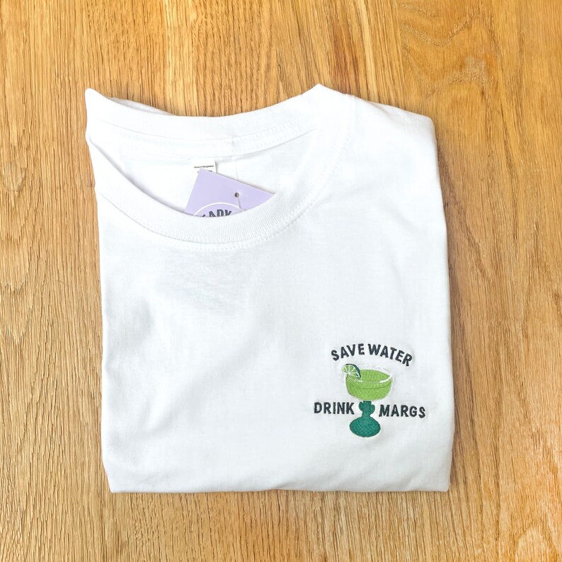 white unisex t shirt with embroidered margarita design
