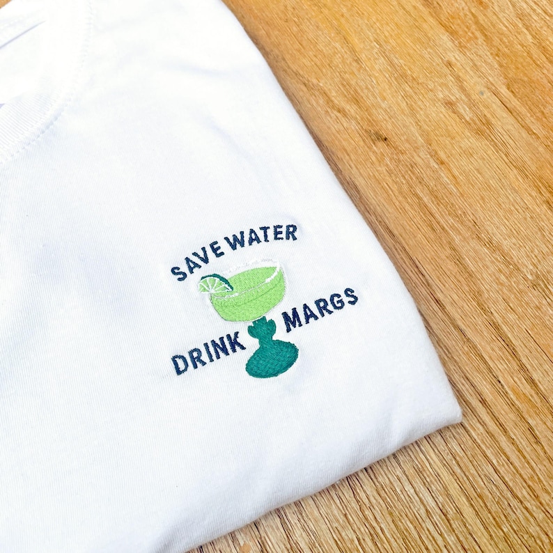 white unisex t shirt with embroidered margarita design